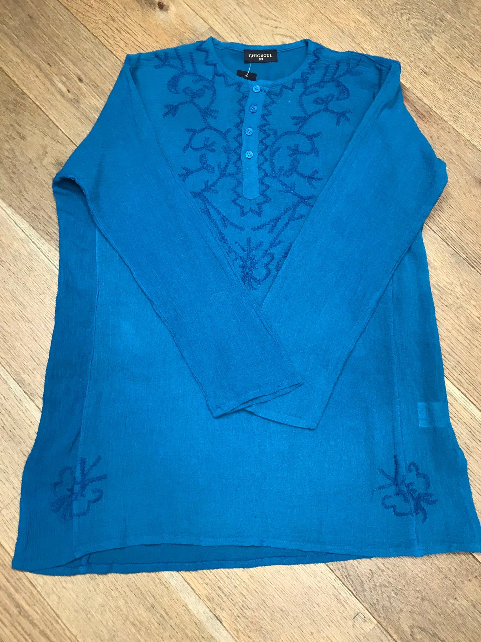 Long sleeves - wear rolled up when the weather's warm Round neck with button placket fastening Self coloured embroidery on the front & back Tie Dye - all slightly different due to hand dye techniques 100% Cotton crepe (cheesecloth) Actual measurements:- Chest approx 44-46”; Back length approx 27-28”; Underarm sleeve approx 17” Cool hand wash - dry out of direct sunlight