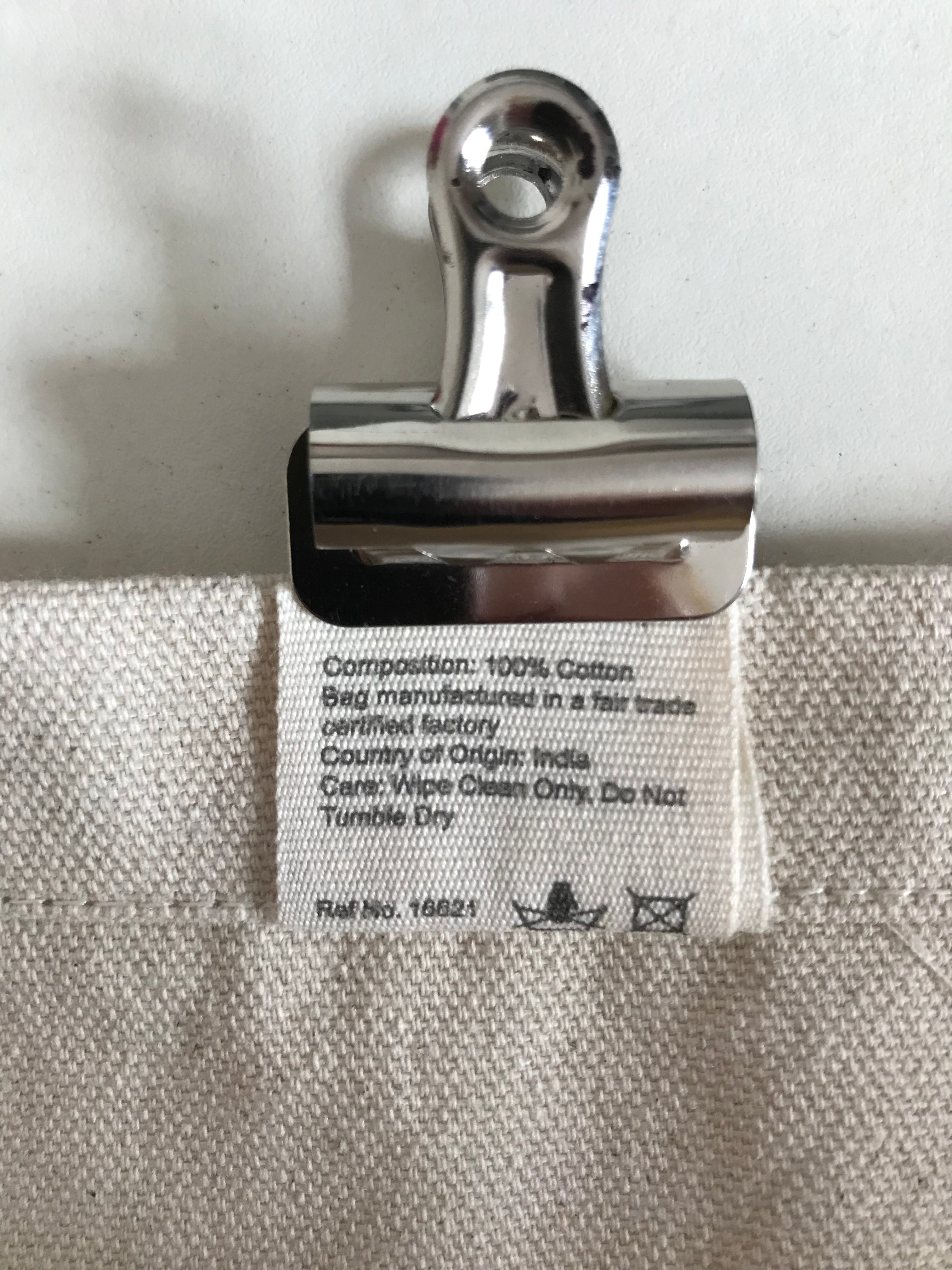 Composition: 100% Cotton.  Bag manufactured in a Fair Trade verified factory.  Country of Origin: India.  Care: Wipe Clean Only.  Do not tumble Dry.